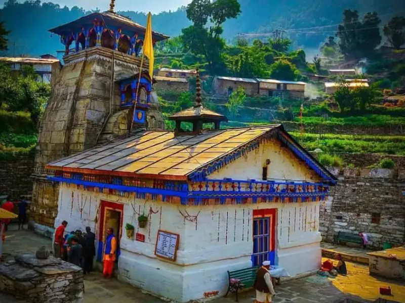 a view of Triyuginarayan temple with mountain in the background of temple